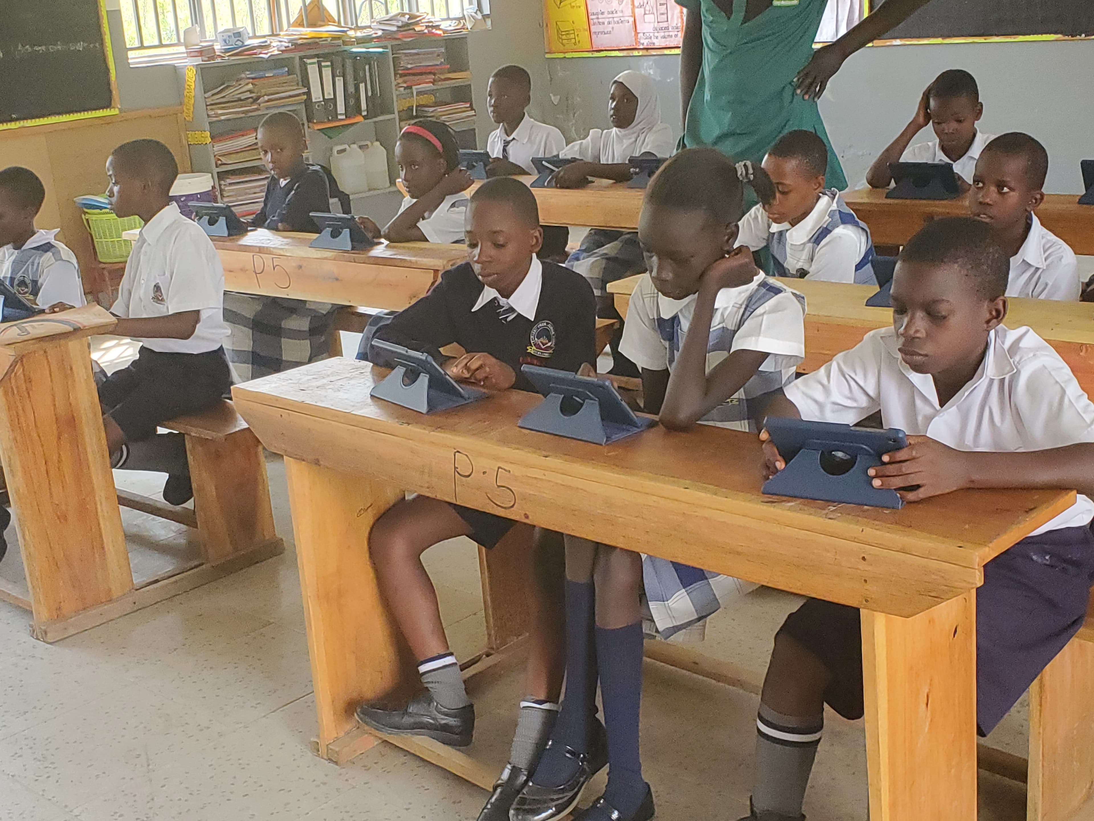 Teachers helping pupils in class